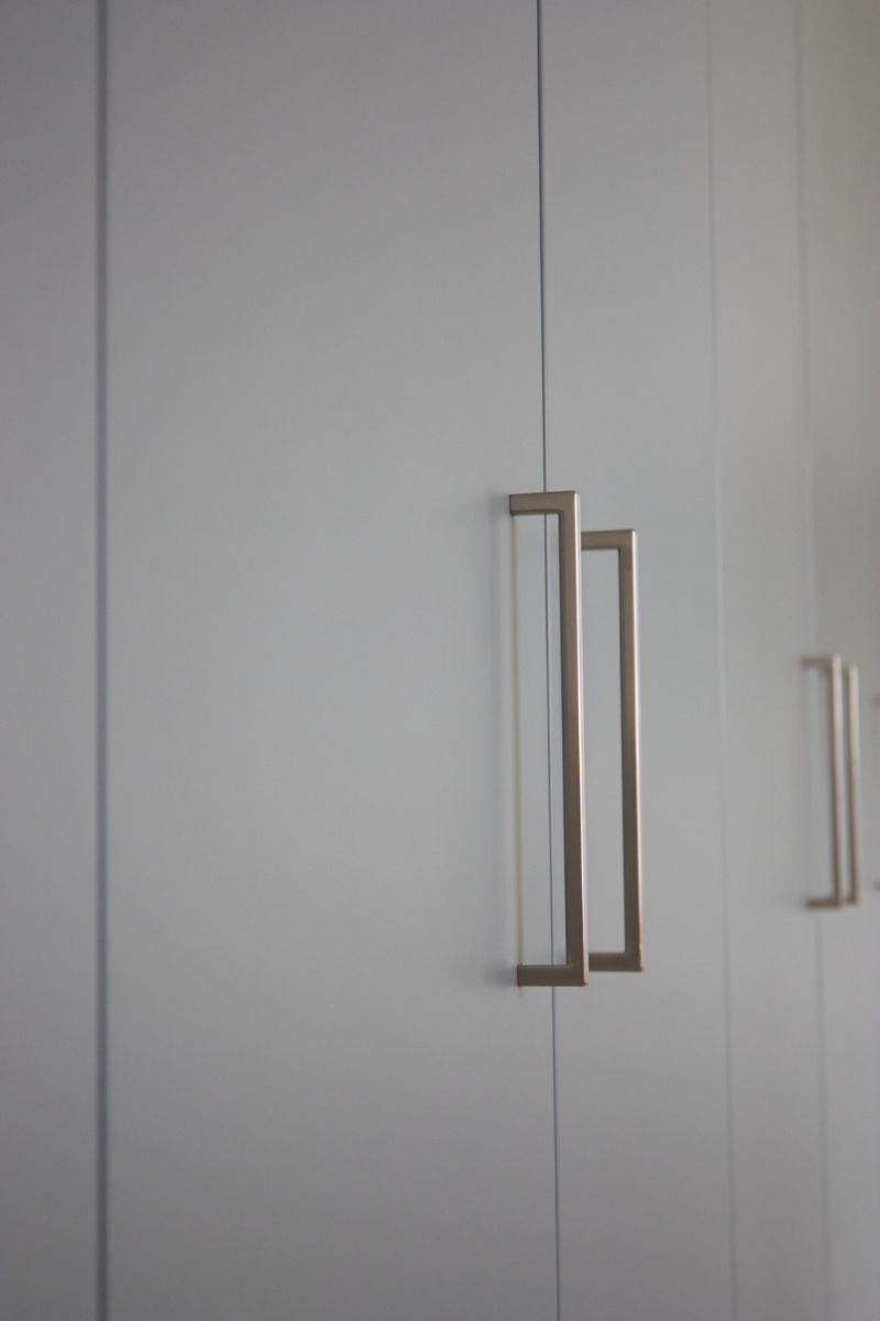 Chrome handles on white fitted wardrobe doors
