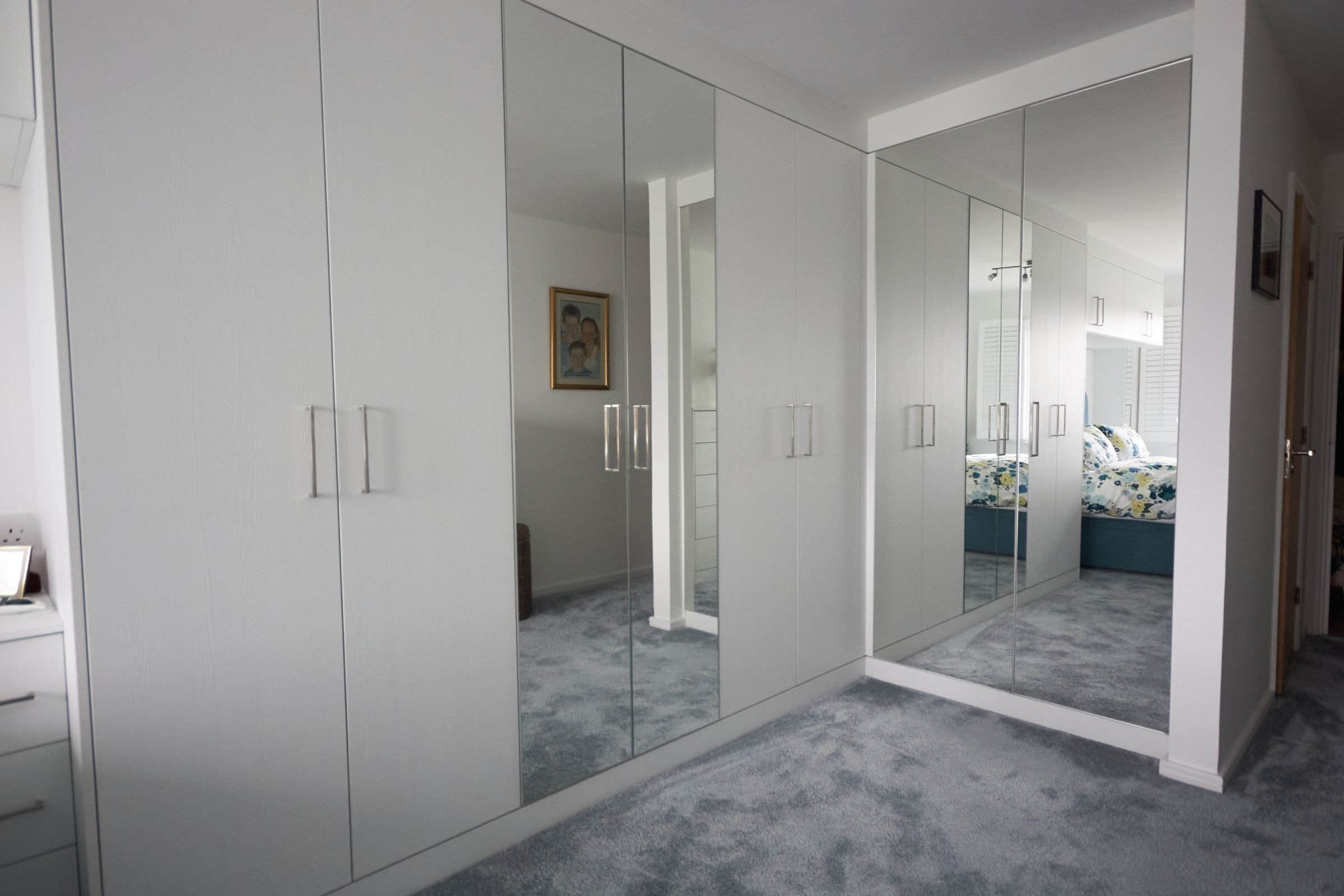 White floor-to-ceiling fitted wardrobes with mirrored doors