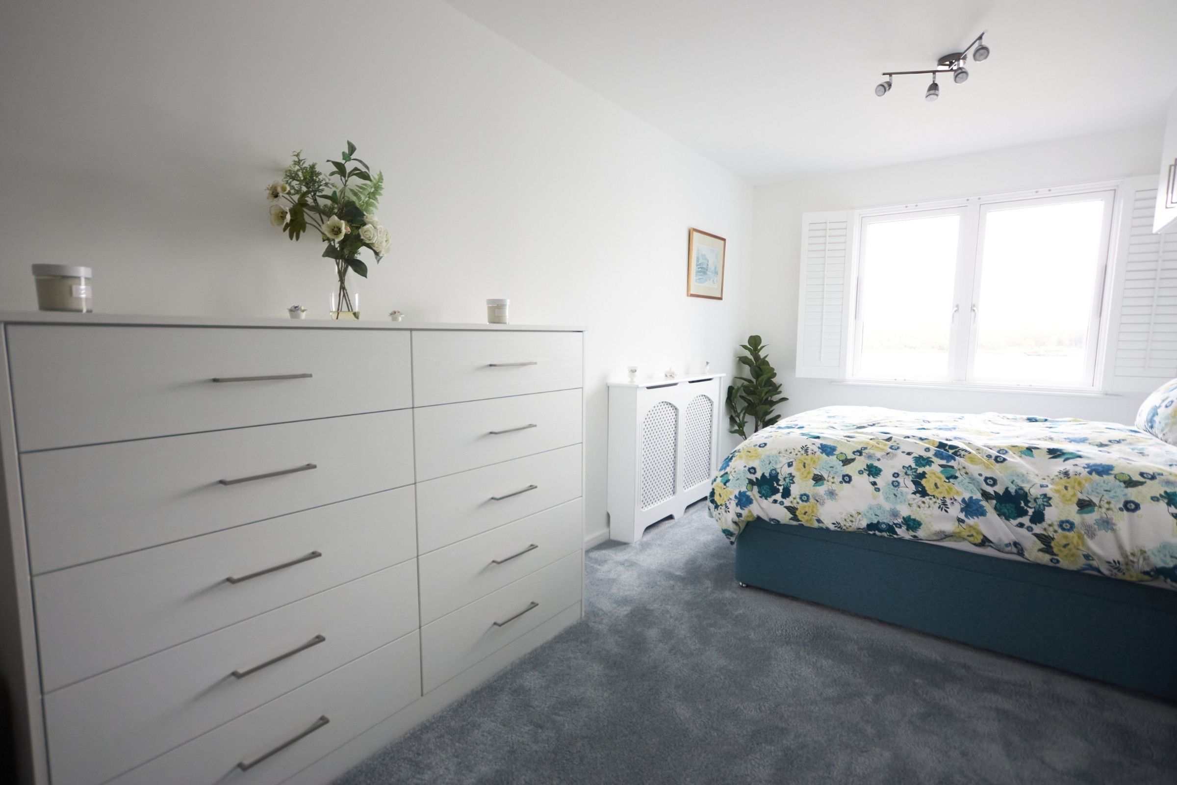 White fitted drawers beside the bed