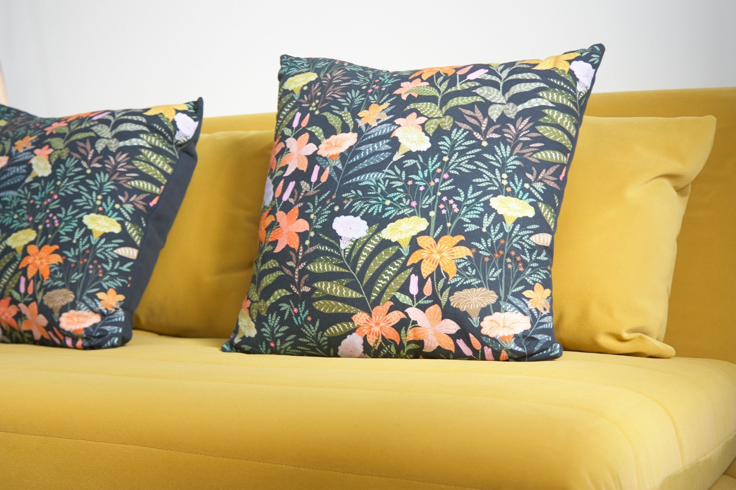 Mustard sofa in a bedroom with blue-grey fitted storage
